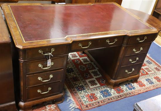 A George III style mahogany pedestal desk with gilt tooled burgundy leather top W.154cm